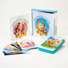 The “Inspirational Visions Oracle Cards” by Schiffer Publishing, Ltd. includes a guidebook, a decorative box, and vivid illustrated cards arranged on white to inspire self-discovery.