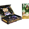 Celestial Frequencies by Schiffer Publishing, Ltd. is shown open with cards and a guidebook featuring a woman in a green robe amid celestial art, offering intuitive guidance.