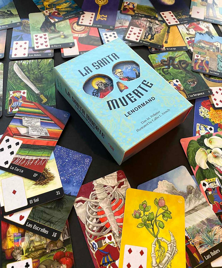 A vibrant array of tarot and divination cards encircles the light blue La Santa Muerte Lenormand box by Schiffer Publishing, Ltd., a deck featuring detailed illustrations, numbers, and suit symbols.
