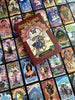 A vibrant Tarot deck with intricate art is spread out, topped by The Zerner/Farber Tarot set from Schiffer Publishing, Ltd., its whimsical guidebook beckoning you to explore your psychic potential.