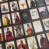 A tabletop displays The Doors of Somlipith by Schiffer Publishing, Ltd., a set of illustrated playing cards featuring unique fantasy artwork and mystical names, evoking the tradition of esoteric tarot and magical card readings.