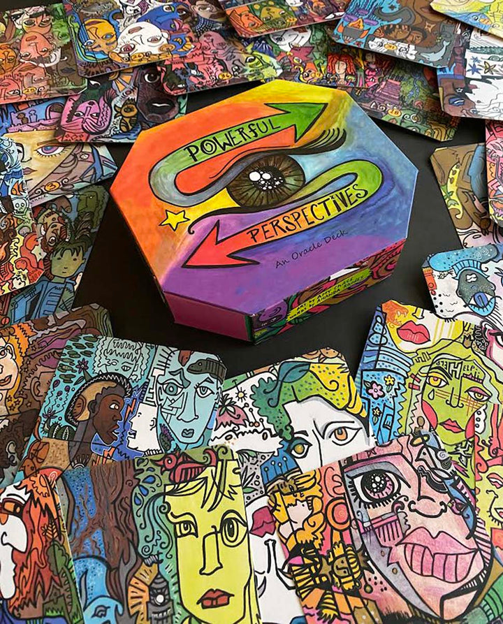 A colorful hexagonal box labeled "Powerful Perspectives" by Schiffer Publishing, Ltd. is shown with vibrant cards featuring diverse abstract faces and designs—ideal for intuitive guidance and empowerment.