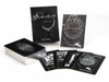 The Nightfall Tarot by Schiffer Publishing, Ltd. is displayed with its 78 illustrated cards inspired by Rider-Waite-Smith, a closed box, and a guidebook. Several cards, such as Wheel of Fortune, are fanned out to show their black-and-white artwork.