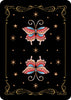 The Nocturnal Garden Lenormand card back by Schiffer Publishing, Ltd. features two vibrant butterflies on black, framed by gold stars and ornate borders—an elegant choice for moon journaling or your divination deck.