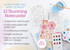 Flat lay of Schiffer Publishing, Ltd.’s Watercolor the Easy Way Paint-Your-Own Watercolor Cards Friends kit with painted/unpainted floral cards, paint palette, brush in water, envelopes, and contents list on a light background.