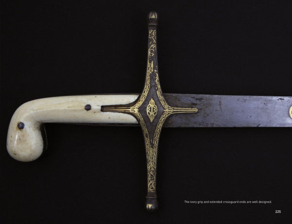 A close-up of a historical sword from Weapons of Warriors by Schiffer Publishing, Ltd. features an ivory-colored curved handle and ornate gold crossguard, reminiscent of Arabic swords, set against a black background.