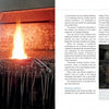 A person in a blue coat works at a blacksmith’s forge in a workshop, surrounded by tools and equipment. The right page of "The Book of Forging" by Schiffer Publishing, Ltd. displays text and images about blacksmithing techniques.