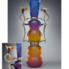 Studio Glass in America" by Schiffer Publishing, Ltd.: An eye-catching vase with a blue-to-orange gradient and whimsical bird-like metal figures on each side; inset reveals a close-up of the birds on the vase’s upper section.