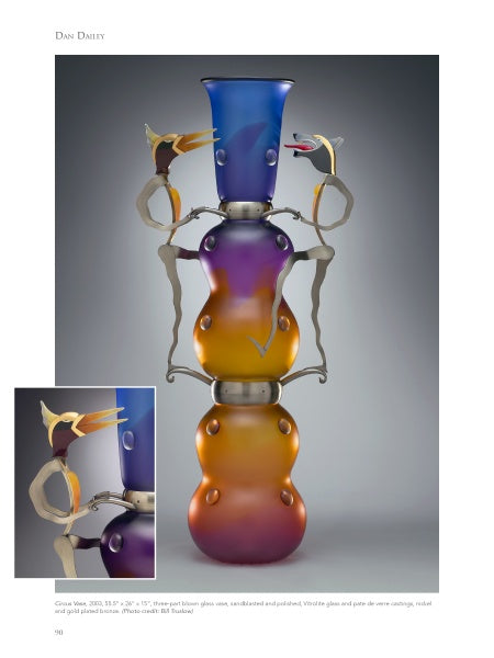 Studio Glass in America" by Schiffer Publishing, Ltd.: An eye-catching vase with a blue-to-orange gradient and whimsical bird-like metal figures on each side; inset reveals a close-up of the birds on the vase’s upper section.