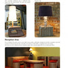 A catalog page features three lamps, including a retro and a modern style, alongside stylish cardboard furniture inspired by "The Great Book of Cardboard Furniture" from Schiffer Publishing, Ltd.