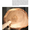 Turning Natural Edge Bowls by Schiffer Publishing, Ltd. features a large, unfinished natural edge bowl on a lathe, with a tool extended inside, ready to shape the bowl during the woodturning process.