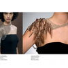 A woman models "On Body and Soul" jewelry by Schiffer Publishing, Ltd.: a metallic, wing-like shoulder armor on her right and a spiked metal with chain design on her left, both paired with a black strapless top.