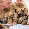 Two soldiers in camouflage and tactical vests study a map outdoors, focused on planning. "Modern Knives in Combat" by Schiffer Publishing, Ltd. is overlaid at the bottom, highlighting their readiness with military knives.