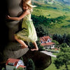 A young girl in a green dress hugs the leg of a giant towering over houses and countryside—a symbol of spiritual growth. "RESOLUTION" and the number 10 appear below in Transformation Oracle by Schiffer Publishing, Ltd.