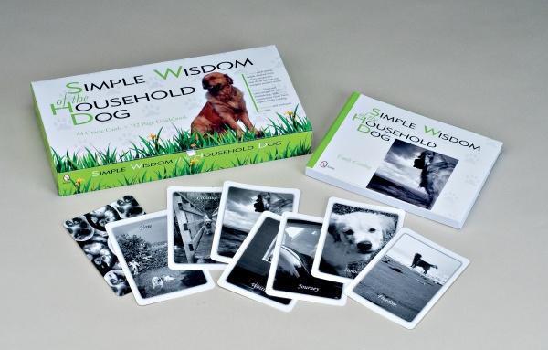 Simple Wisdom of the Household Dog by Schiffer Publishing, Ltd. is displayed, featuring a book and black-and-white dog oracle cards inspired by the household dog tarot, all spread out in front.