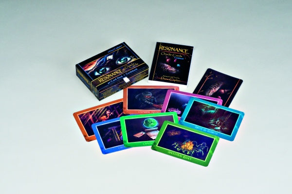 The Resonance Oracle by Schiffer Publishing, Ltd. features mystical, cosmic-themed cards with a guidebook and box, offering spiritual guidance—all displayed on a white background.