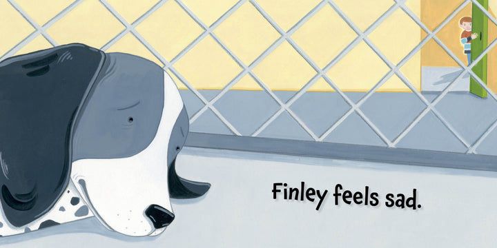 A sad black and white dog named Finley lies behind a kennel fence as a boy peeks through a green door. "Finley Feels" by Schiffer Publishing, Ltd. helps kids gently explore emotions, with the text reading, “Finley feels sad.”.