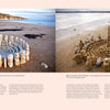 Two images from "Land Art" by Schiffer Publishing, Ltd. show circular sculptures of stacked rocks on sandy beaches. Each features balanced stones forming concentric rings near the water, with cliffs and the sea in the background.
